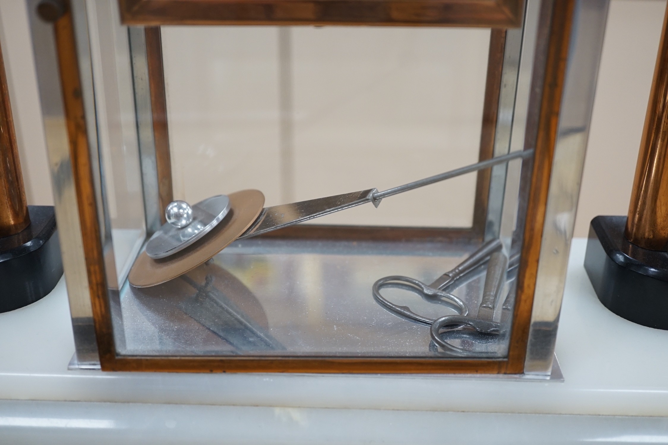 An Art Deco chrome, copper, brass and alabaster four glass mantel clock, 54cms wide
